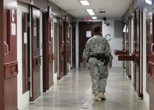 A guard walks through a cellblock inside Camp V, a prison used to house detainees at Guantanamo Bay U.S. Naval Base